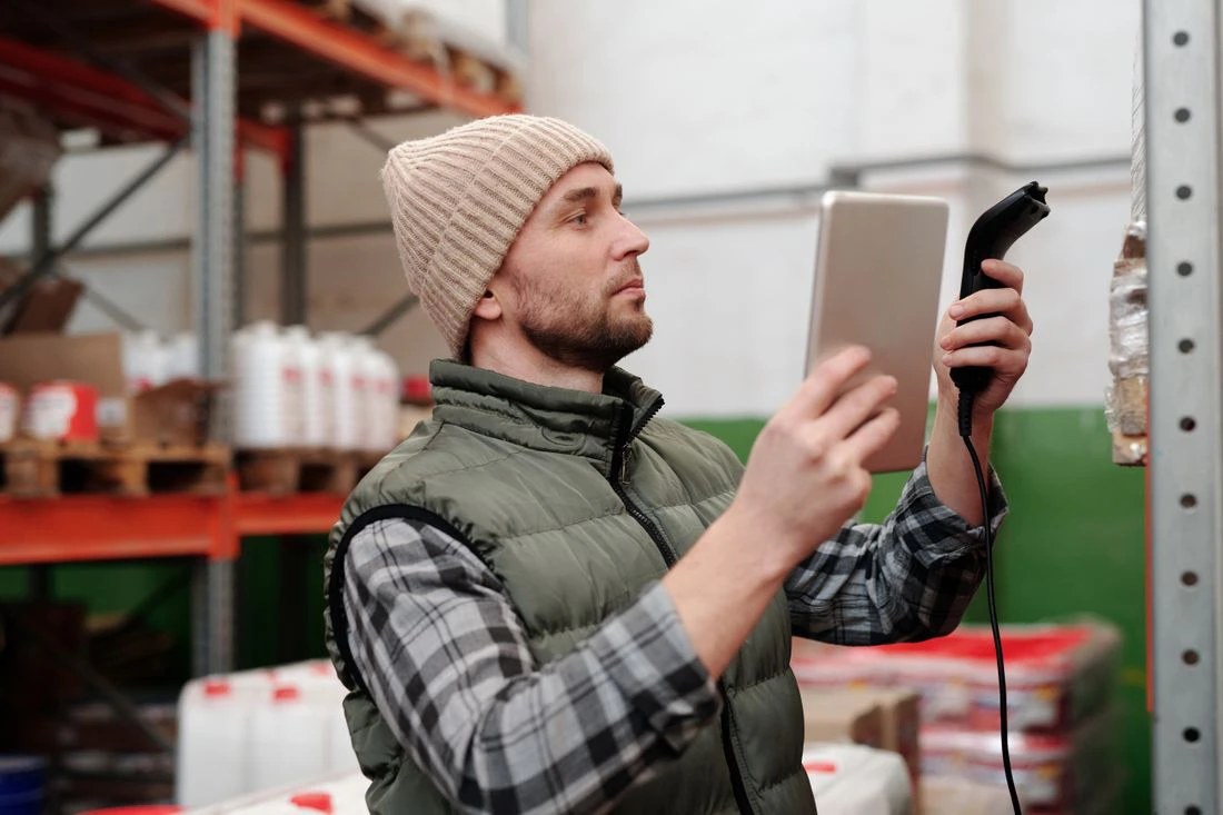 Operator scanning a lot coded pallet label to record a traceability event