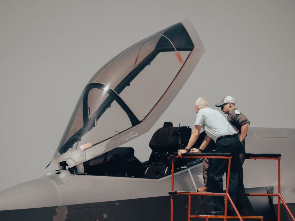 Technician logging teardown findings in MRO software at the bench