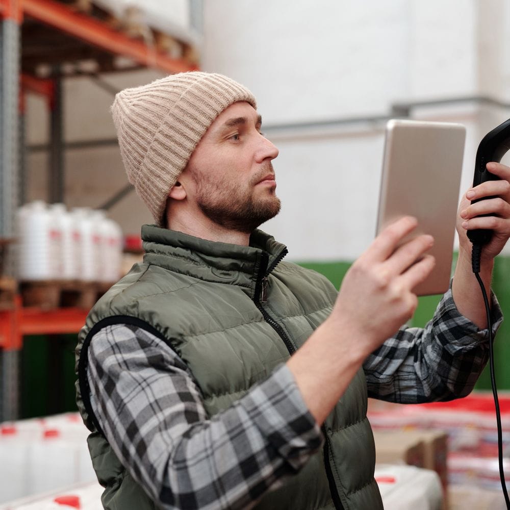 Warehouse team scanning lot coded stock to verify traceability records in a food business