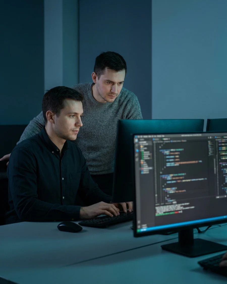Two developers coding side by side, building integrations