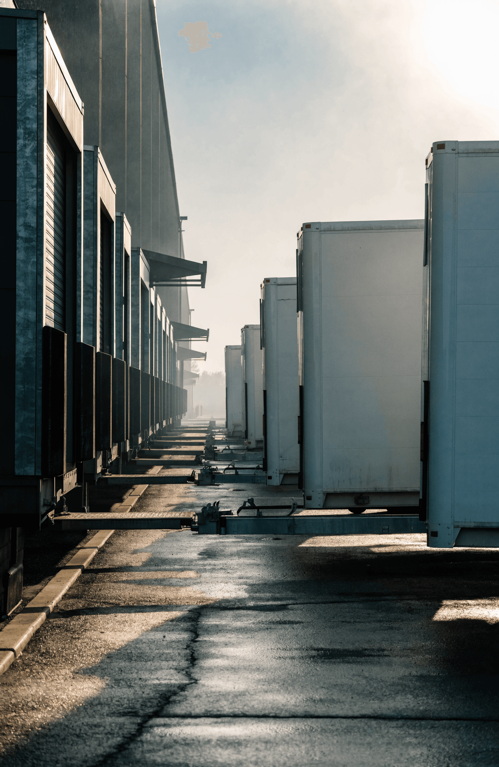 Row of trailers at dock doors, the point where most logistics systems stop agreeing with each other