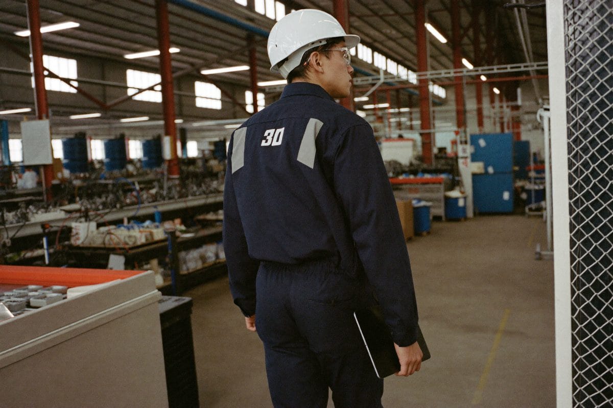 Manufacturing engineer walking the production line with a work tablet in hand