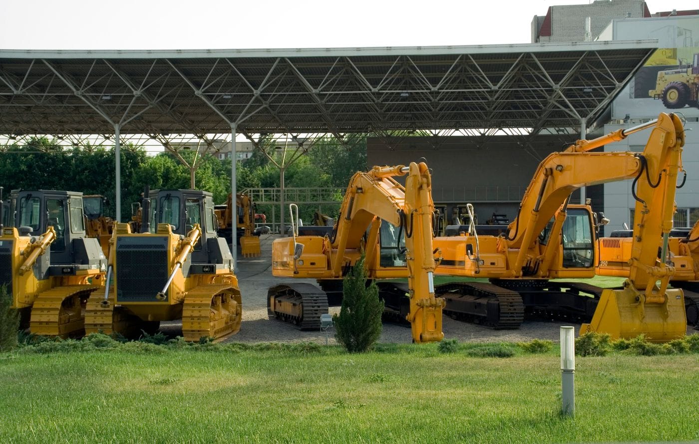 Rental fleet of excavators and heavy machinery in an equipment yard