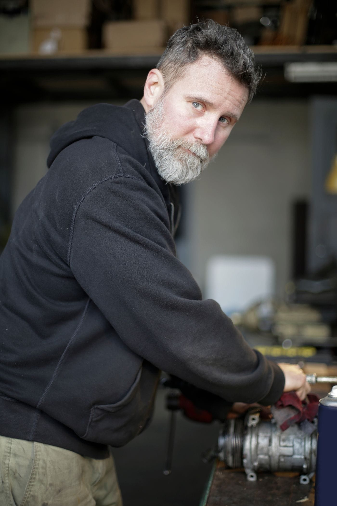 Technician performing preventive maintenance on rental equipment
