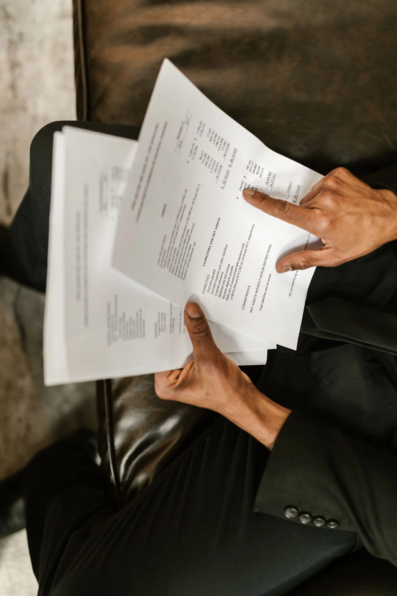 Overhead view of hands reviewing a financial document